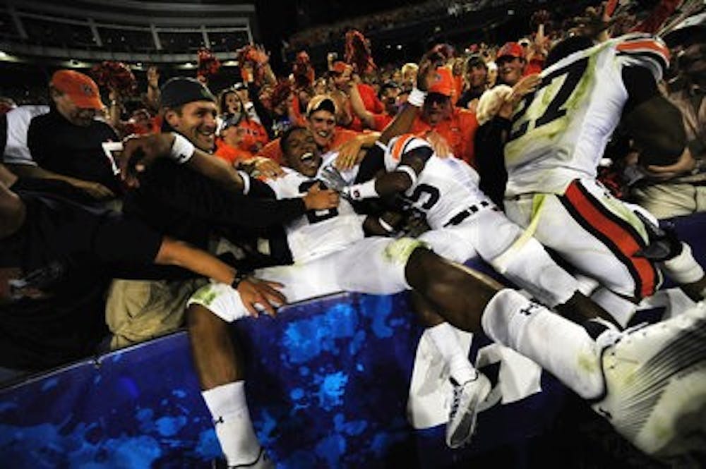 Cam Newton celebrates with fans. (Todd Van Emst / Auburn Media Relations)