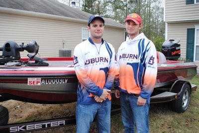 Matt Lee (left), president of bass fishing team and Jordan Lee (right), tournament director, pose by their boat. (Maria Iampietro / PHOTO EDITOR)