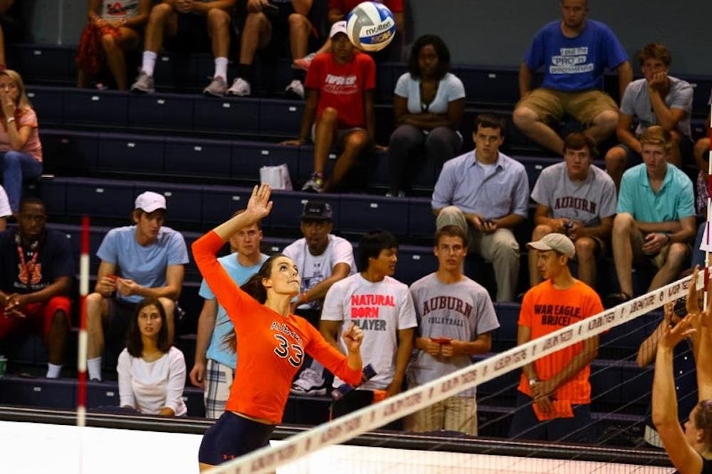 Macy Reece (#33) jumps up to hit the ball. (Kenny Moss | Photographer)