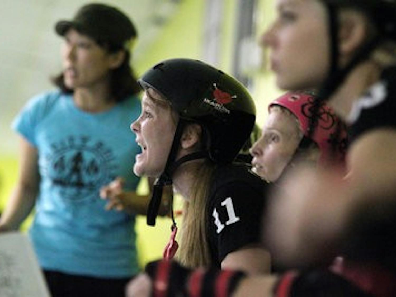 Amyn Atcha cheers on the Burn City Rollers. The all-girl roller derby team will compete in 13 bouts in the 2011 season. (Emily Adams / PHOTO EDITOR)