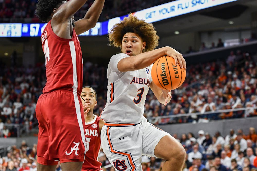 Auburn guard Tre Donaldson (3) goes for two against Alabama during a matchup in Neville Arena on Feb. 11, 2023.