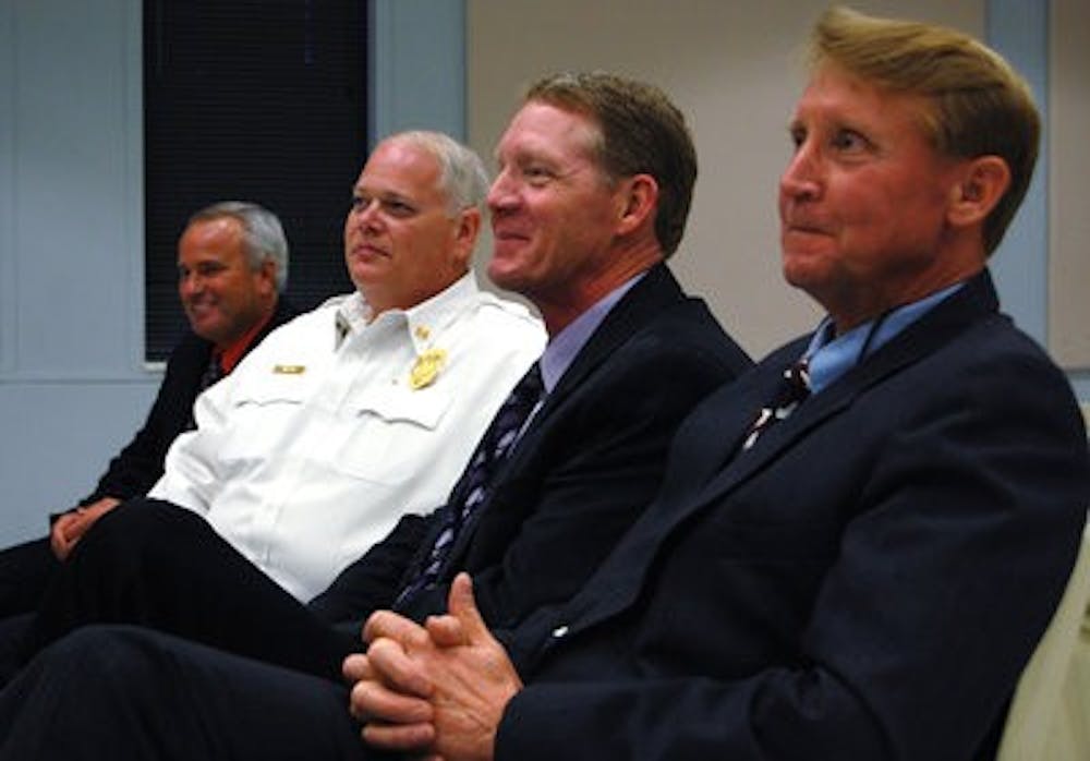 Chief of Police Tommy Dawson, Fire Chief Lee Lamar, Public Safety Director Bill James and Communications Administrator Benjie Walker listen during a Public Safety meeting Thursday. Each of their departments will lead a session explaining its duties. (Rebekah Weaver / ASSISTANT PHOTO EDITOR)