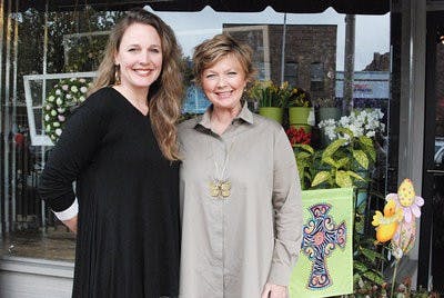 Sarah Brown and Terry Shea smile outside their Auburn store