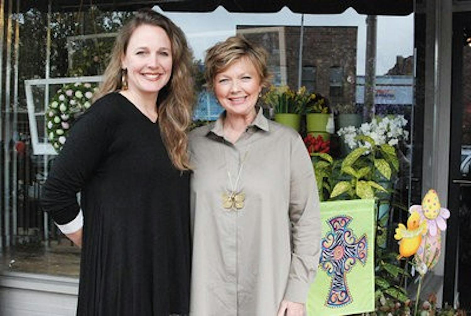 Sarah Brown and Terry Shea smile outside their Auburn store