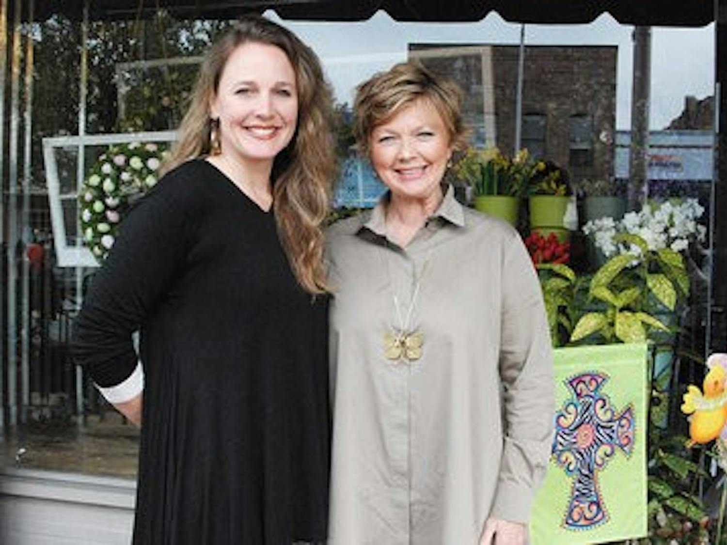 Sarah Brown and Terry Shea smile outside their Auburn store