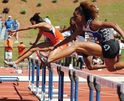Senior Latoya Parkinson runs the 100-meter hurdles at the War Eagle Invitational held in Auburn April 15-16. Parkinson won the Olympic Development hurdles in 13.86 seconds. (Maria Iampietro / Associate Photo Editor)