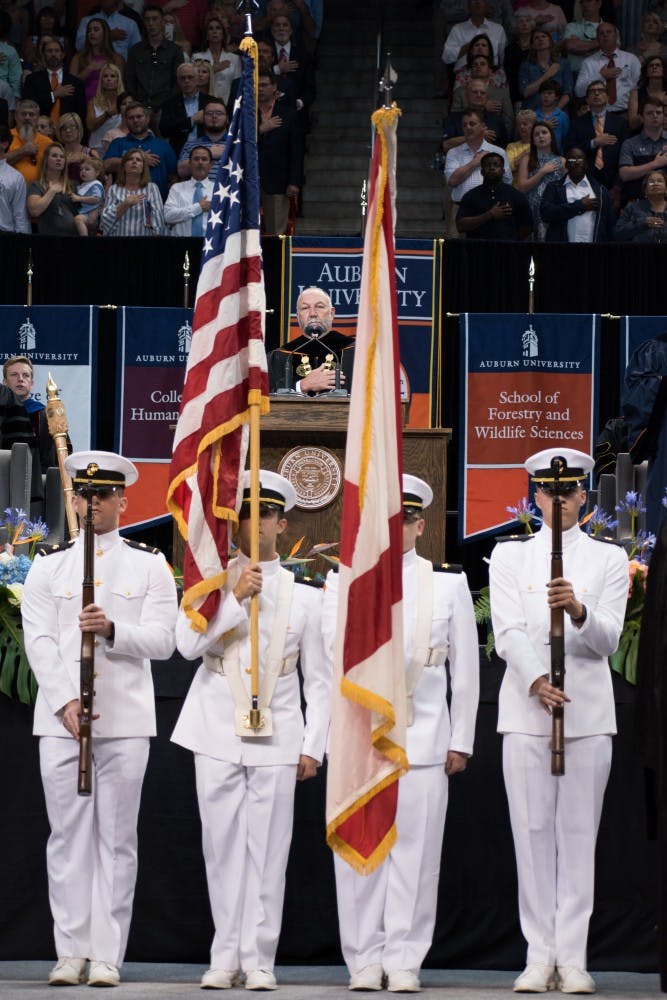 The honor guard stands with the flags at the graduation ceremony on Sunday, May 6, 2018, in Auburn, Ala.