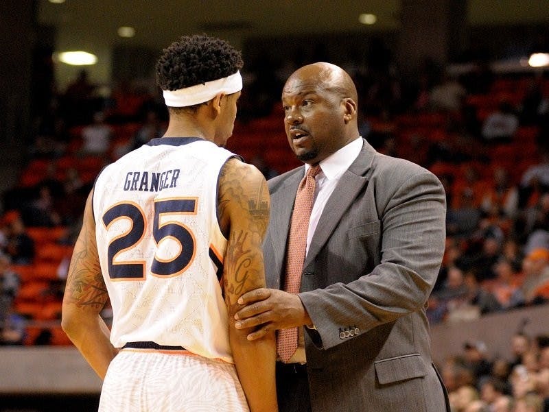 Assistant Coach Chuck Person has a chat with Jordon Granger during a timeout. Auburn vs Arkansas in Auburn, AL on Feb. 10, 2015. Adam Sparks | Photographer
