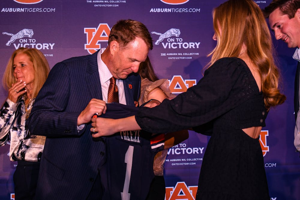 <p>Hugh Freeze is introduced as the 31st head coach of the Auburn football team, surrounded by family and Auburn Athletic Director John Cohen at the Woltosz Football Performance Center on Nov. 29, 2022.</p>