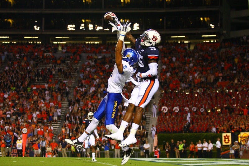 Trovon Reed (#25) hits ball. Auburn vs. San Jose, Sept. 6, 2014. (Kenny Moss | Photographer)