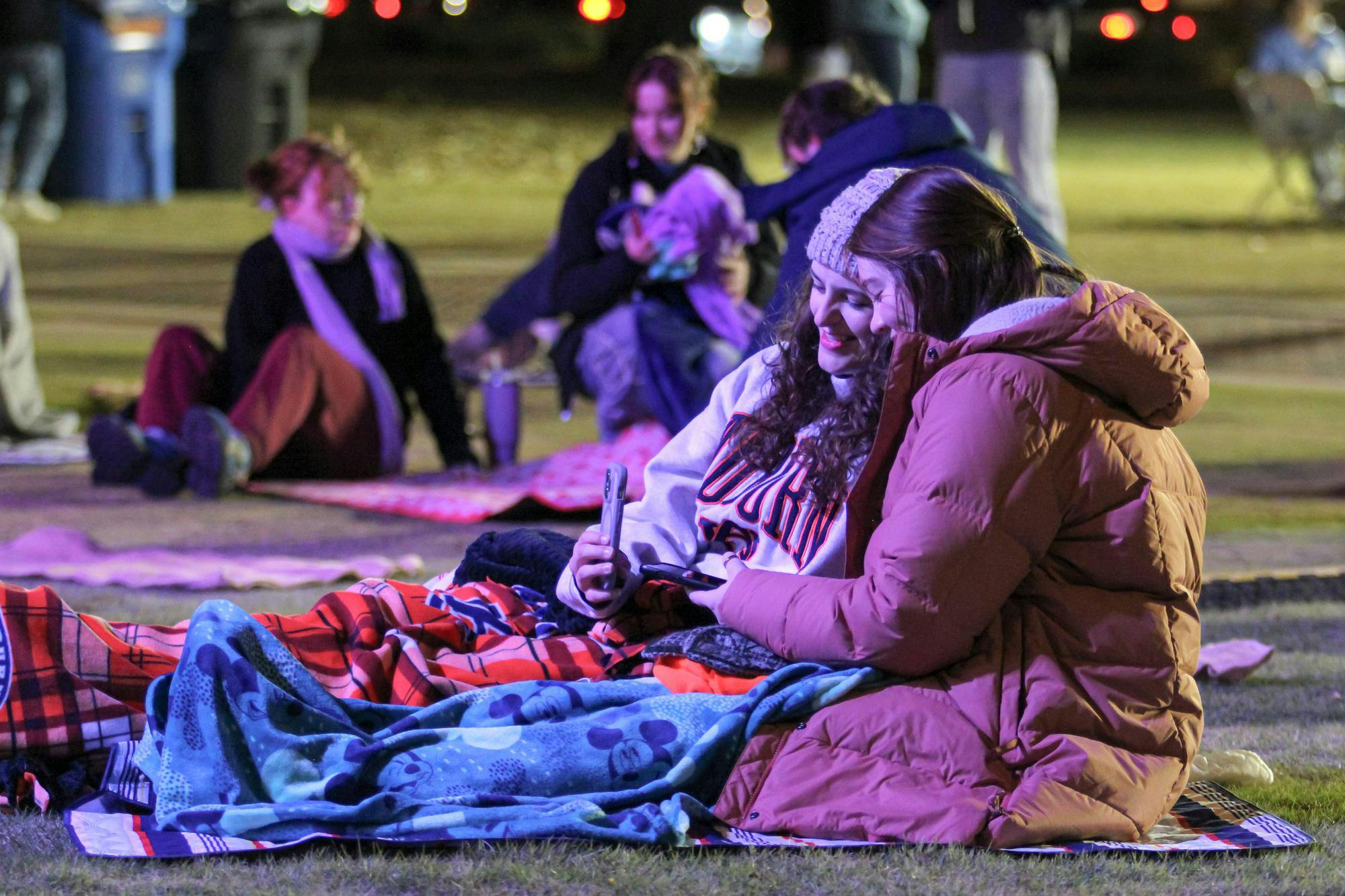 Two attendees of War Damn Coffee Jam take a selfie in their blankets before the first band starts at Samford Lawn in Auburn, Ala. on Nov. 11, 2025.