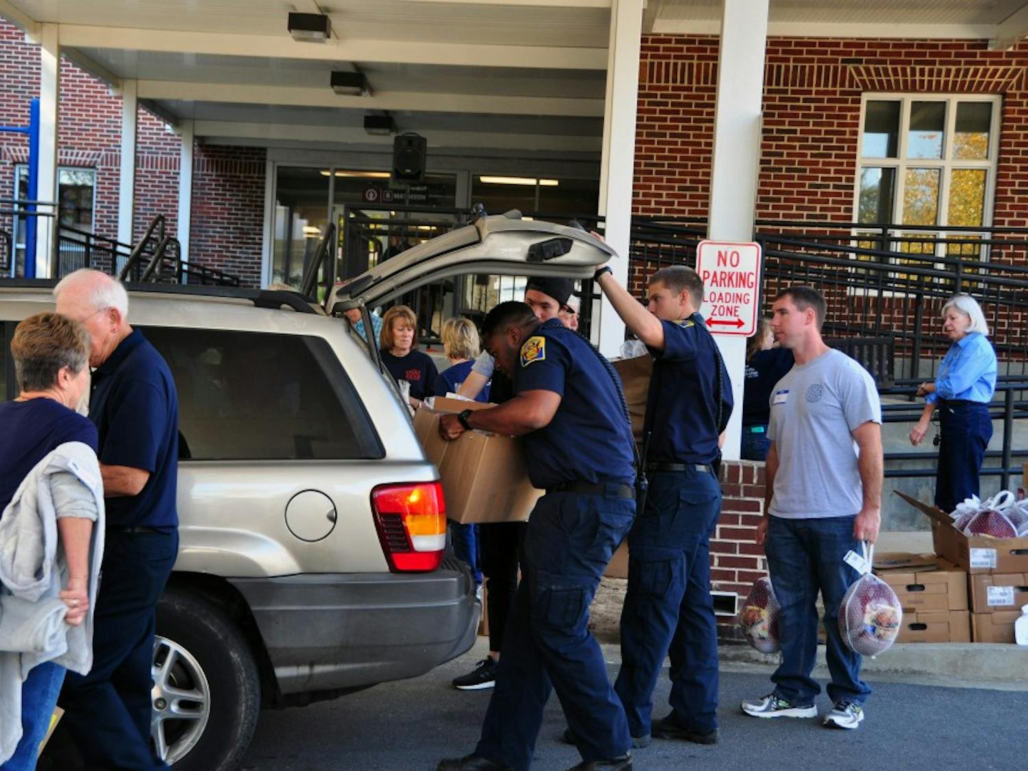 Auburn firefighters and community members&nbsp;place Thanksgiving food boxes in a car at Auburn United Methodist Church on Friday, Nov. 18, 2016.