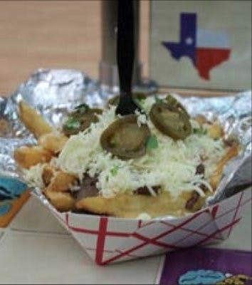 Tex's Tacos very own texicana fries are steak, guacamole, pico de gallo, grilled onions, queso fresco, cilantro, and salsa on fries. (Kelsey Davis / INTRIGUE WRITER)