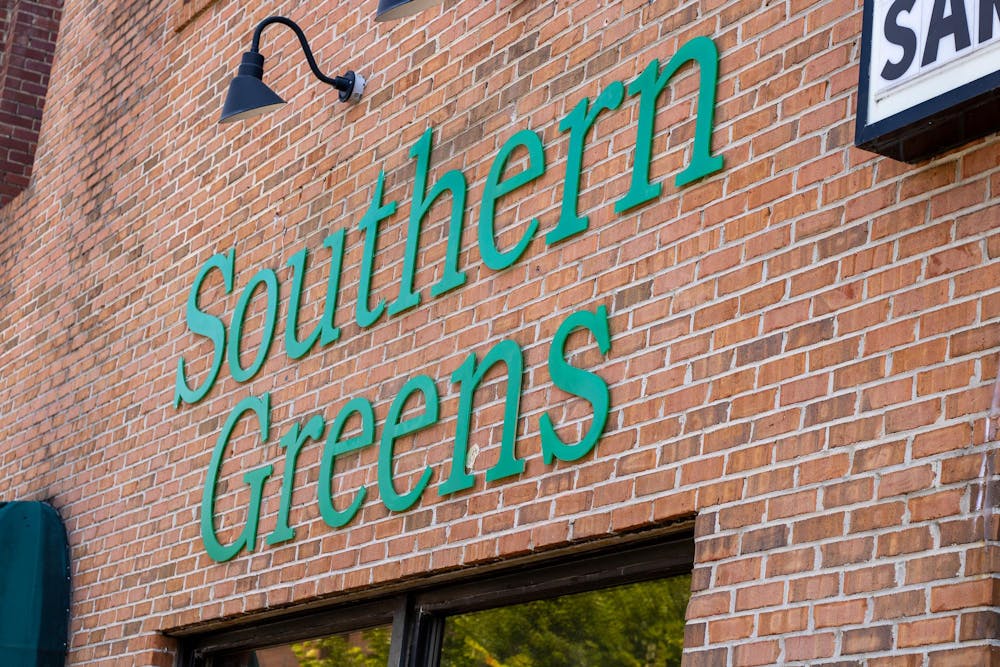 <p>The sign on the front of new Downtown Auburn restaurant displaying the name of the restaurant, Southern Greens, in bold green letters on Sept. 18, 2025.</p>