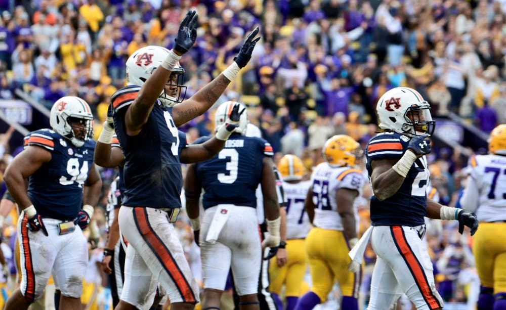 <p>Jamien Sherwood (9) and Jeremiah Dinson (20) celebrate a defensive stop during Auburn football at LSU on Oct. 26, 2019, in Baton Rouge, La. LSU won, 23-20.</p>