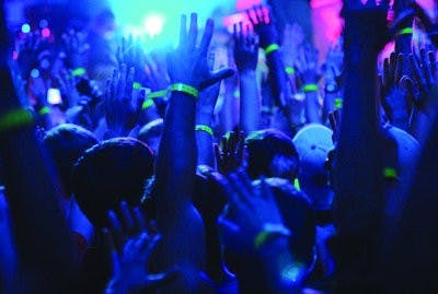 Fans throw their hands up to the sounds of Girl Talk Thursday for UPC's fall concert. (Maria Iampietro / PHOTO EDITOR)