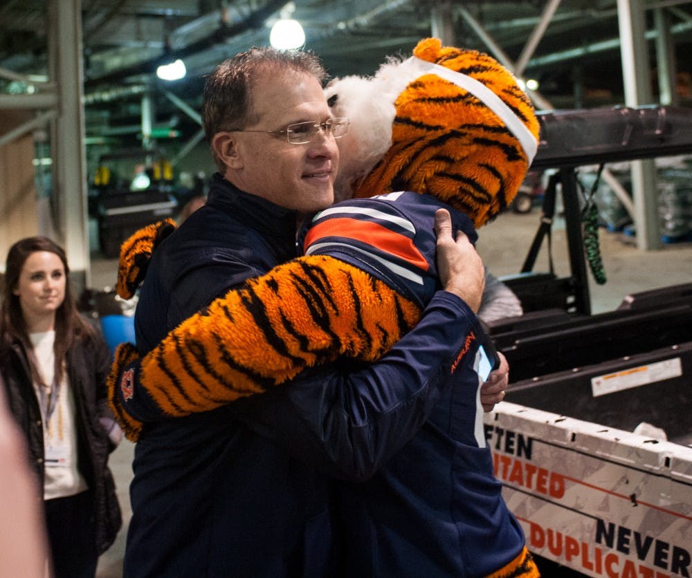 Aubie gives head coach Gus Malzahn a hug after the game. Auburn vs Alabama on Saturday, Nov. 25 in Auburn, Ala.