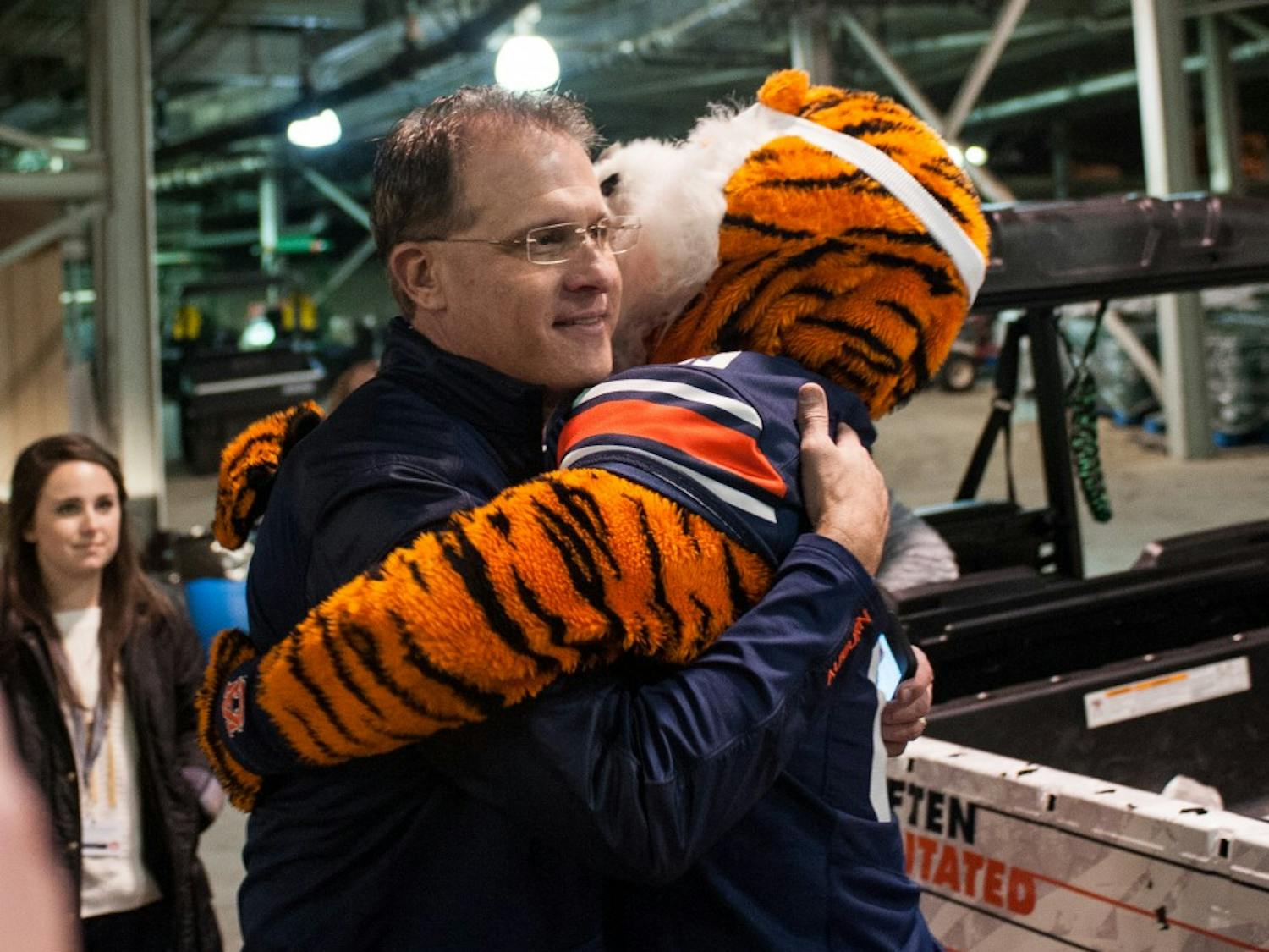 Aubie gives head coach Gus Malzahn a hug after the game. Auburn vs Alabama on Saturday, Nov. 25 in Auburn, Ala.