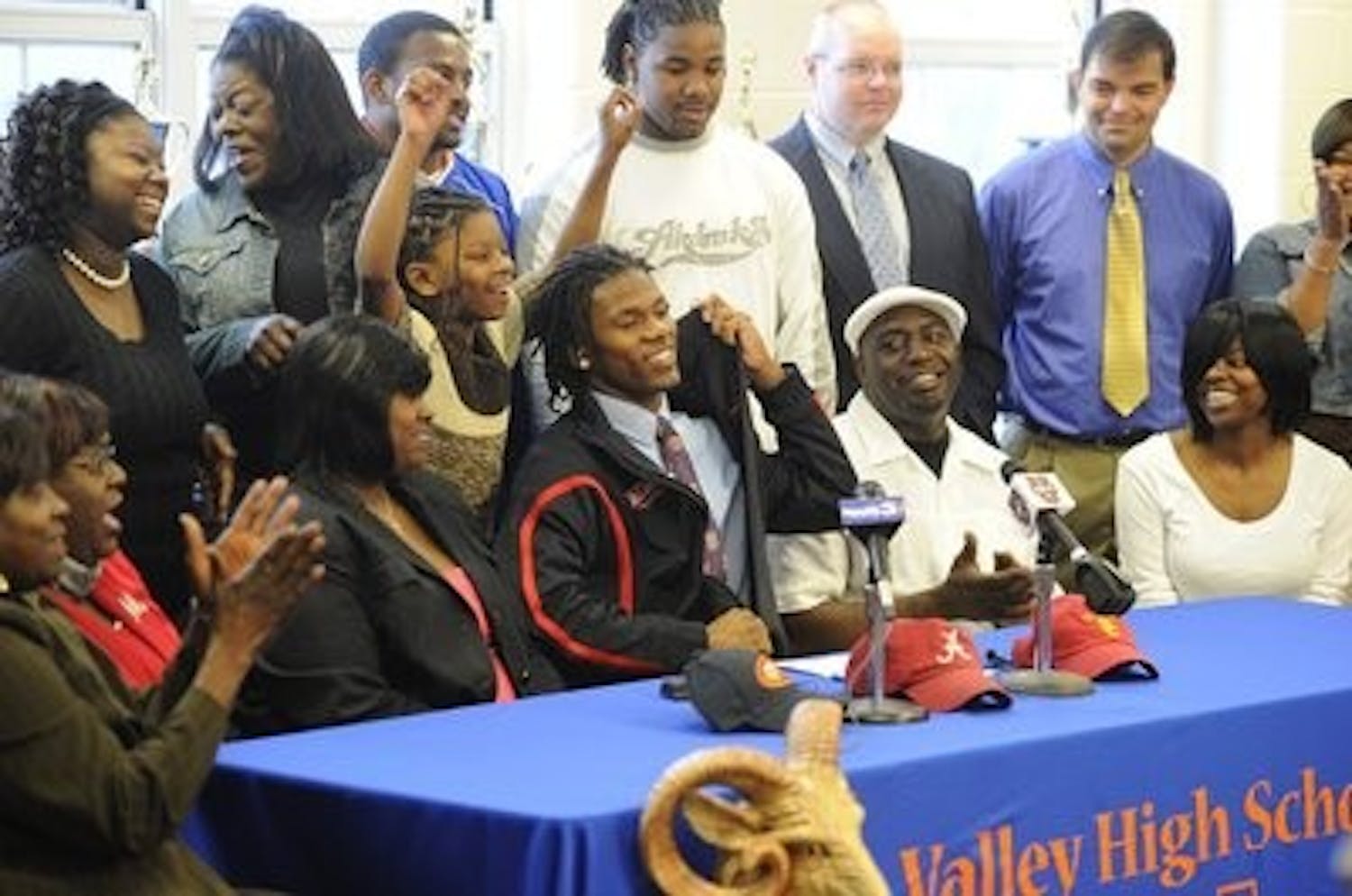 Valley High School star Erique Florence unzips his jacket to reveal an Auburn tie on National Signing Day last year. (Photo courtesy of the Opelika-Auburn News)