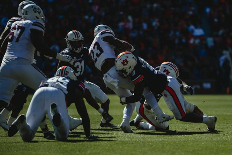 Zakoby McClain (9) makes a tackle against Mississippi State on Nov. 13, 2021 in Auburn, AL.