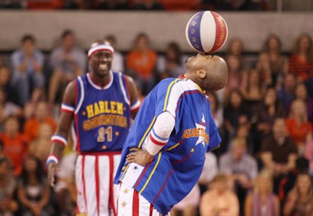 Harlem Globetrotter Scooter Christensen balances a ball on his nose at the opening of the Auburn Arena. (Photos by Emily Adams / Photo Editor)