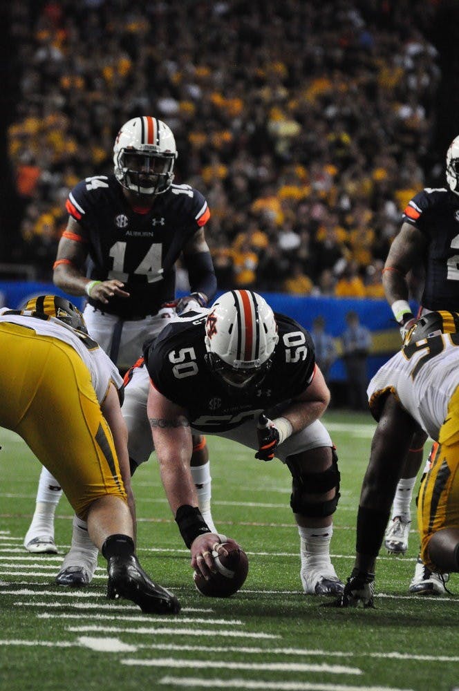 Quarterback Nic Marshall waits for the snap from center Reese Dismukes. Anna Grafton / PHOTO EDITOR