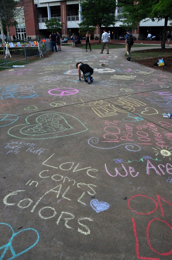 An array of chalk art decorates the walkway to the Green Space outside the Auburn Unites concert on campus on Tuesday, April 18, 2017,&nbsp;in Auburn, Ala. The concert was held to protest white nationalist Richard Spencer's event on the same evening.