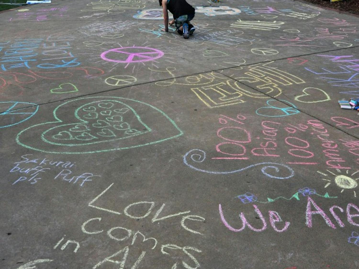 An array of chalk art decorates the walkway to the Green Space outside the Auburn Unites concert on campus on Tuesday, April 18, 2017,&nbsp;in Auburn, Ala. The concert was held to protest white nationalist Richard Spencer's event on the same evening.