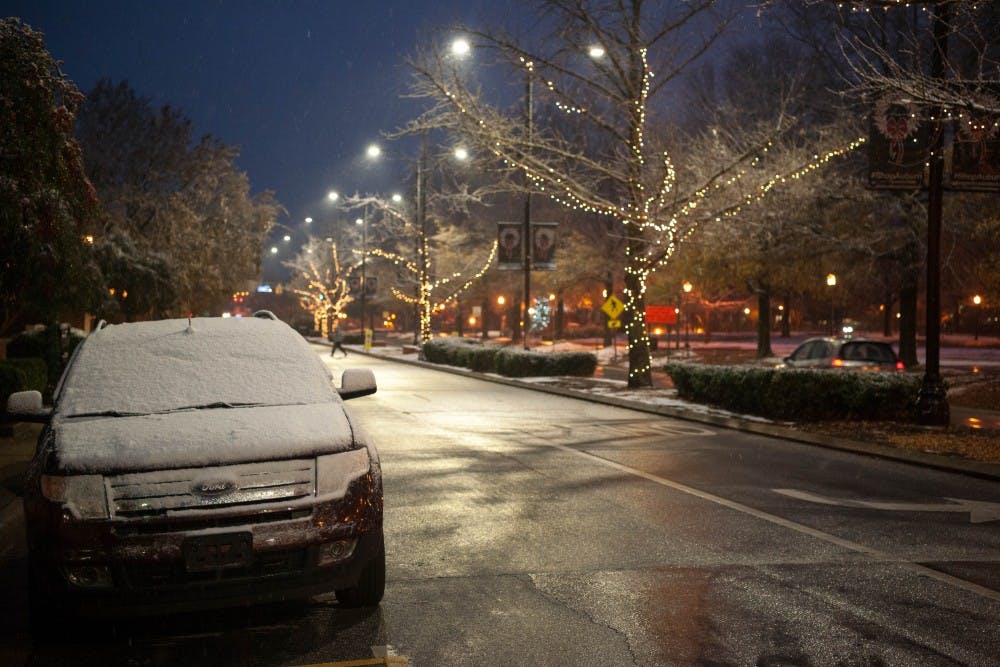 Snow sits on a car in downtown Auburn during the Christmas season.
