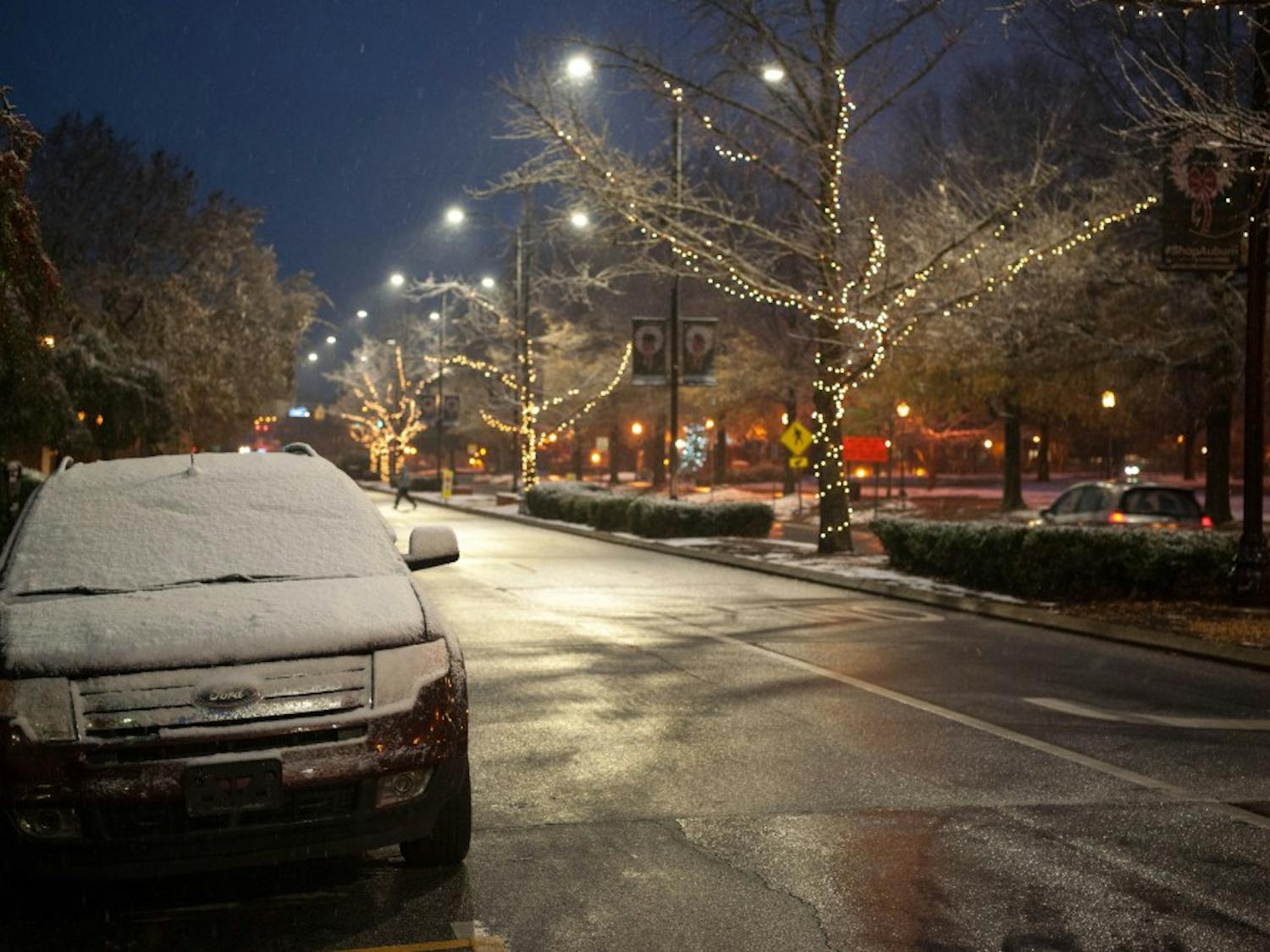 Snow sits on a car in downtown Auburn during the Christmas season.