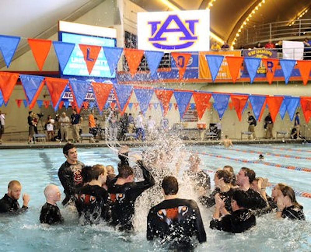 The Auburn men celebrate winning the SEC Championship Feb. 19, in Gainesville, Fla. The win marked the 15th consecutive conference title for the Tigers.(Todd Van Emst / Auburn Media Relations)