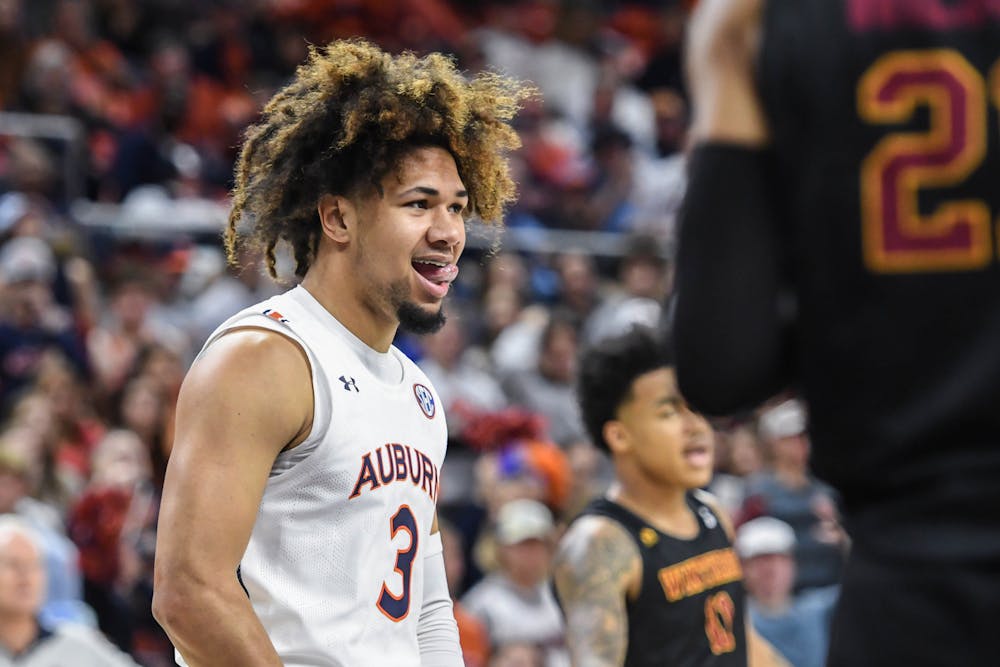<p>Auburn guard Tre Donaldson (3) smiles at a defender during a game against the Winthrop Eagles in Neville Arena on Nov. 15, 2022.</p>