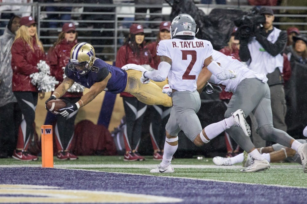 Washington running back Myles Gaskin (9) dives for the pylon to score his third touchdown of the game in the Huskies' 41-14 win over Washington State in the Apple Cup on Nov. 25, 2017, in Seattle, Washington. Contributed by the UW Daily sports desk.