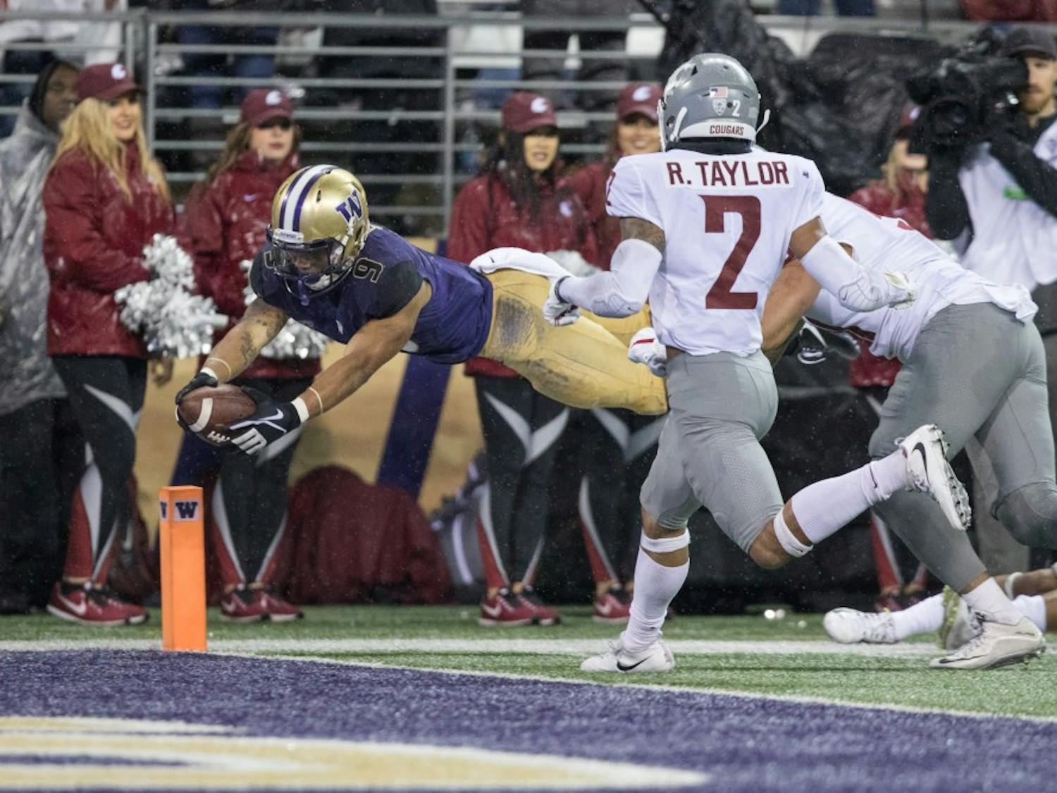 Washington running back Myles Gaskin (9) dives for the pylon to score his third touchdown of the game in the Huskies' 41-14 win over Washington State in the Apple Cup on Nov. 25, 2017, in Seattle, Washington. Contributed by the UW Daily sports desk.