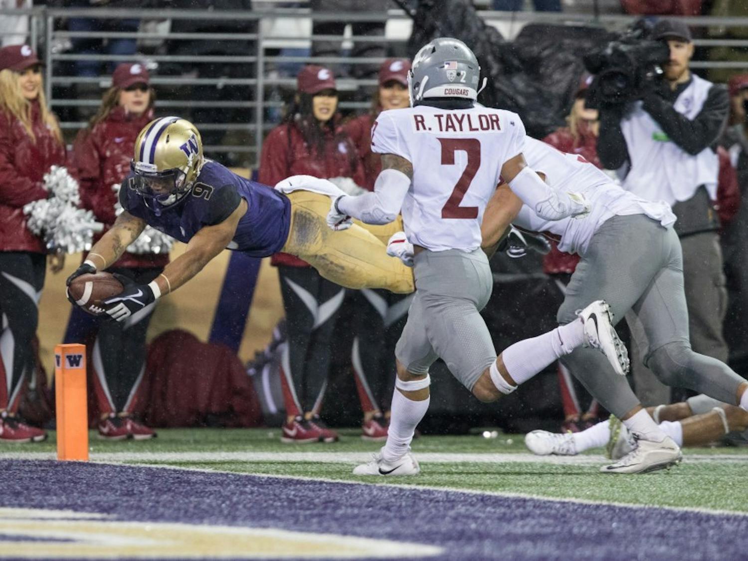 Washington running back Myles Gaskin (9) dives for the pylon to score his third touchdown of the game in the Huskies' 41-14 win over Washington State in the Apple Cup on Nov. 25, 2017, in Seattle, Washington. Contributed by the UW Daily sports desk.