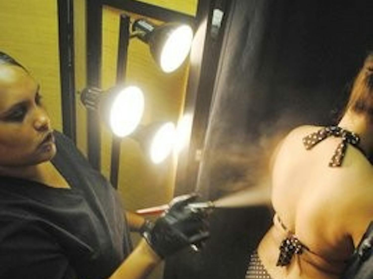 Sonya Hildreth, co-owner and manager of Create A Spa, gives a customer an organic, hand-crafted spray tan. (Maria Iampietro / COPY WRITER)