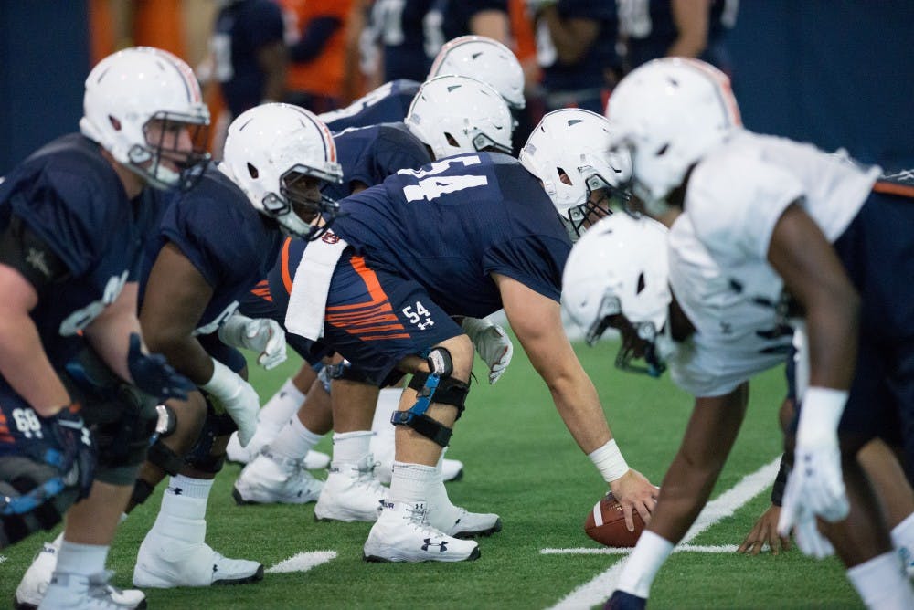 Kaleb Kim (54) prepares to snap&nbsp;at Auburn's football practice on Thursday, March 29, 2018, in Auburn, Ala.