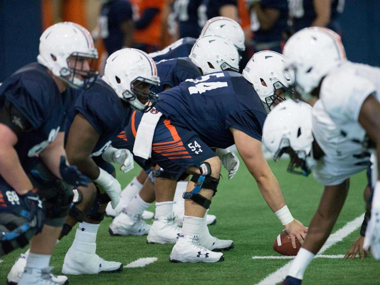 Kaleb Kim (54) prepares to snap at Auburn's football practice on Thursday, March 29, 2018, in Auburn, Ala.