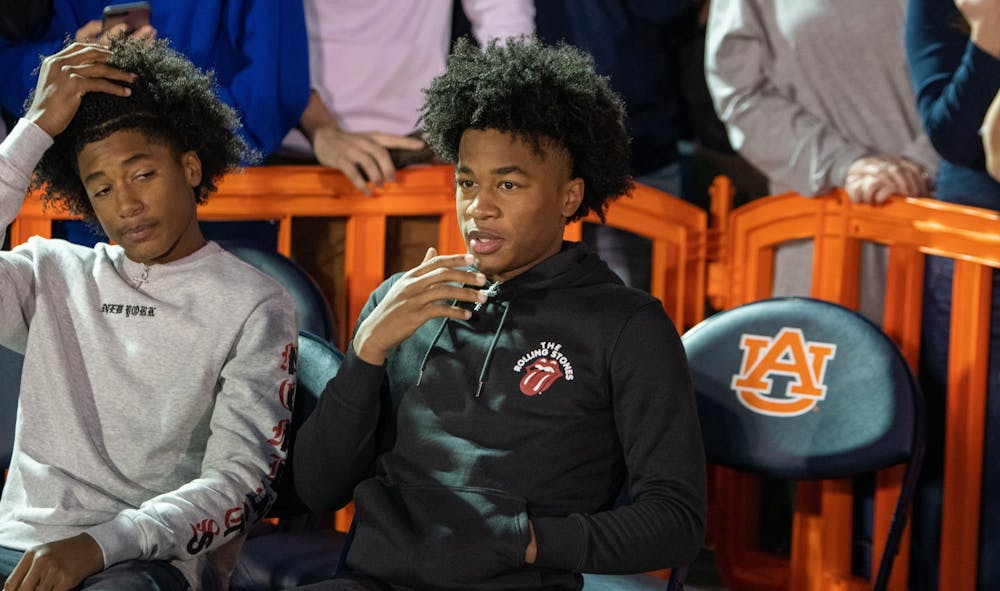 <p>5-star Auburn signee Sharife Cooper (right) watches the court during Tipoff at Toomer's, on Thursday, Oct. 17, 2019, in Auburn, Ala.</p>