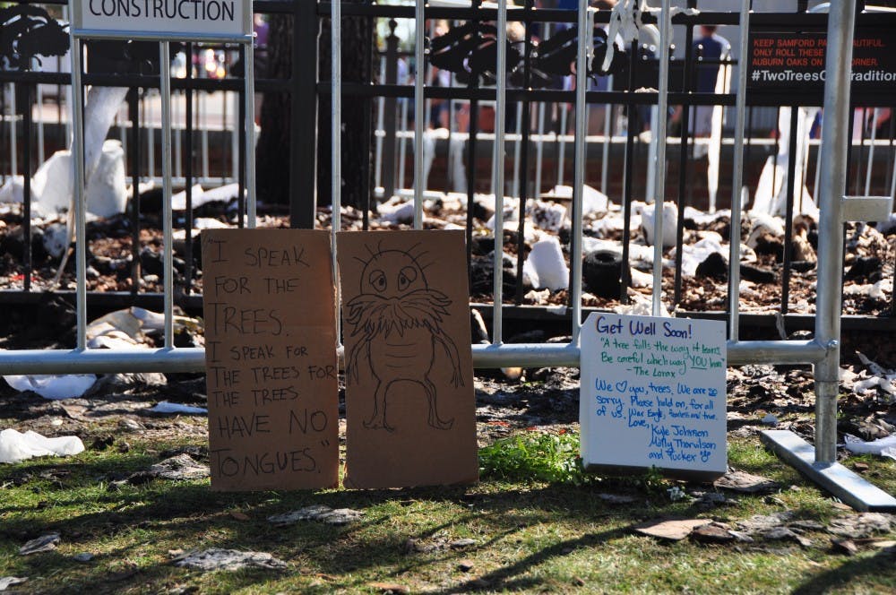 Auburn alumna&nbsp;Molly Thorvilson and her boyfriend Kyle Johnson placed handmade notes at the&nbsp;base of&nbsp;the Toomer's Oak on Magnolia on Sunday, Sept. 25, 2016. Thorvilson said she thought the story from the Lorax captured the spirit of the&nbsp;tree, which&nbsp;was set ablaze early Sunday morning after Auburn's 18-13 win over LSU.