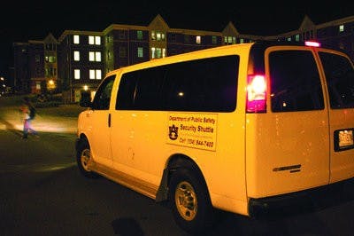 A security shuttle picks up passengers Monday night at one of its frequent stops, the Village. (Derek Lacey / Associate Campus Editor)