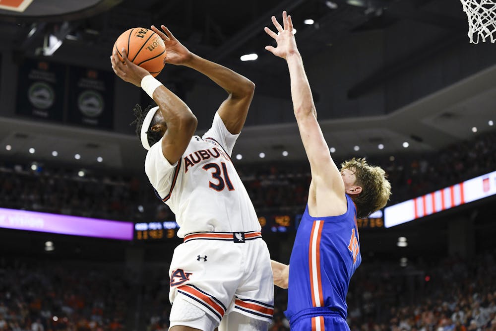 Auburn Forward Chaney Johnson (31) shoots while Florida defense attempts a block during a matchup against the Florida Gators in Neville Arena on Feb. 8, 2025.