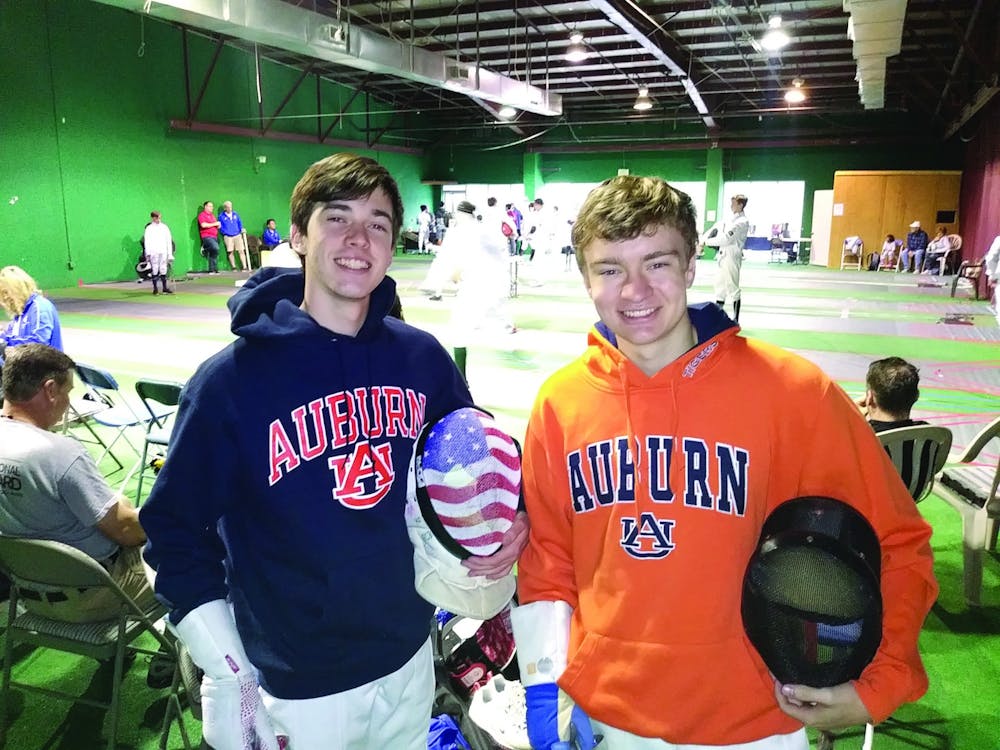 Jay Parcelewicz and Jack Armistead  compete at a fencing tournament.  