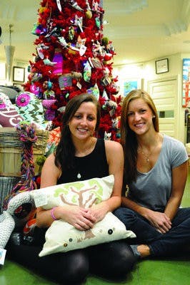 Mary Iraggi and local jewelry designer Kate Kirby (left) model some of Kirby's pieces, which are sold at The Villager. Kirby is one of 10 local artists who will be featured at the Nov. 25-27 show. (Christen Harned / ASSISTANT PHOTO EDITOR)