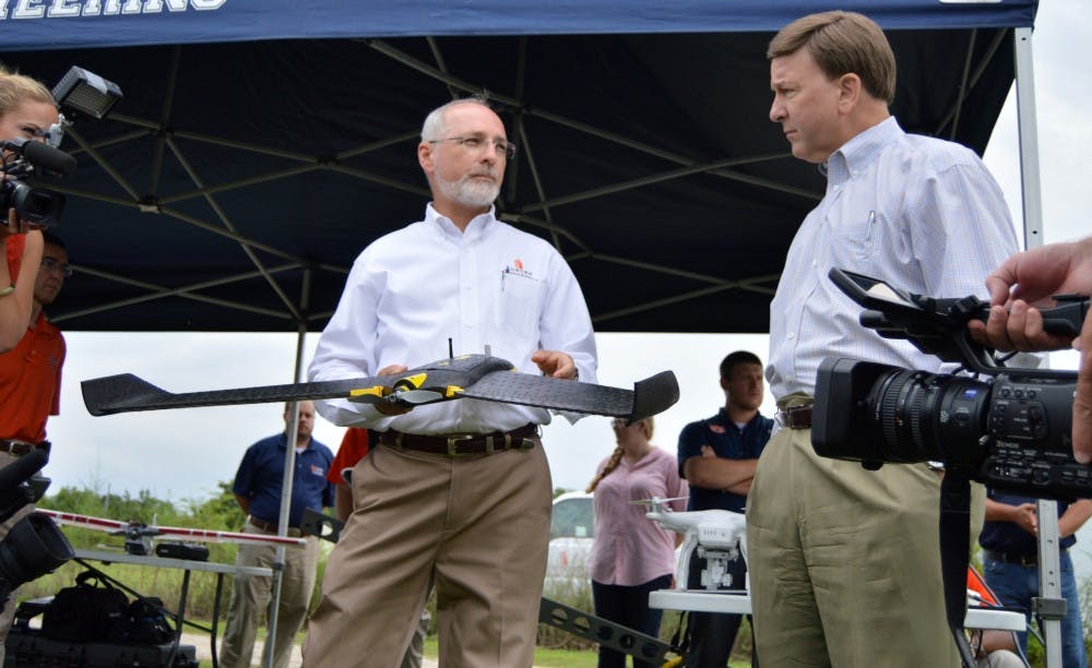 <p>Steve Taylor,&nbsp;Director of the Bioenergy and Bioproducts Center, presents the Ebee senseFly drone to U.S. Rep. Mike Rogers on Tuesday, Aug. 11, 2015, during a UAS demonstration.&nbsp;</p>