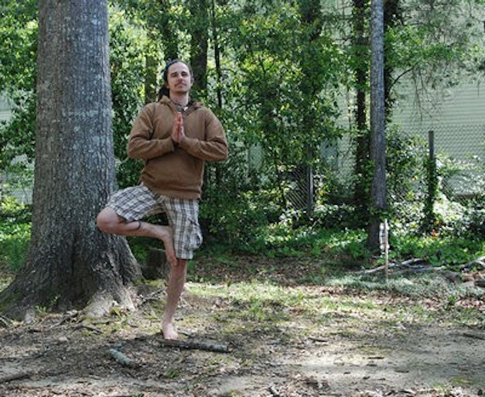 Rosco Davis in tree stance in his yard (Emily Enfinger | Assistant Photo Editor)