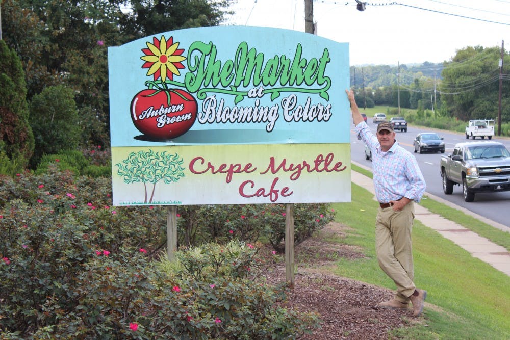 King Braswell, owner of the Crepe Myrtle Café, stands next to the sign for the restaurant, located at the corner of South College Street and South Donahue Drive, on Wednesday, Aug. 23, 2017, in Auburn, Ala.