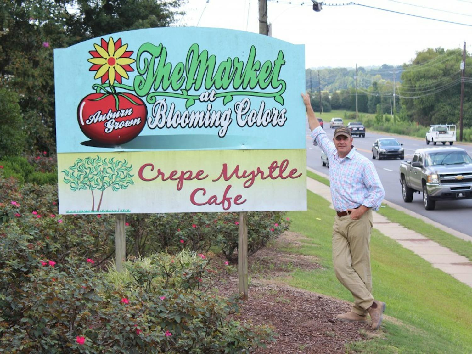 King Braswell, owner of the Crepe Myrtle Café, stands next to the sign for the restaurant, located at the corner of South College Street and South Donahue Drive, on Wednesday, Aug. 23, 2017, in Auburn, Ala.