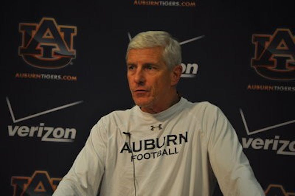 Ellis Johnson speaking to the media after practice. (Anna Grafton / PHOTO EDITOR)