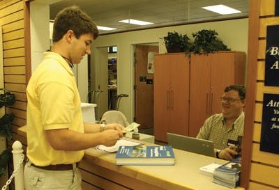 Jared Robinett, a sophomore in business administration, counts the money he receives from selling one of his texts books back.